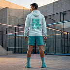 Back view of a model wearing the electric cyan Sweet Spot hoodie showing the bold back branding. www.lobstory.eu